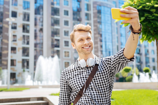 Delighted positive man taking a selfie - Photo, image