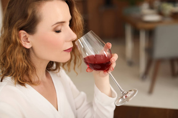 Woman with glass of delicious wine indoors - Φωτογραφία, εικόνα
