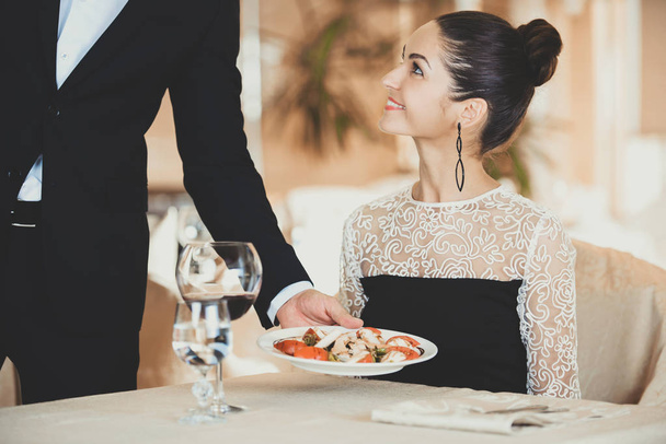 Waiter Serving Plate of Salad to Woman Guest - Foto, immagini