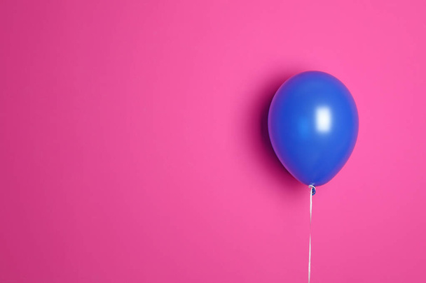 Blue balloon on color background. Celebration time - Fotó, kép
