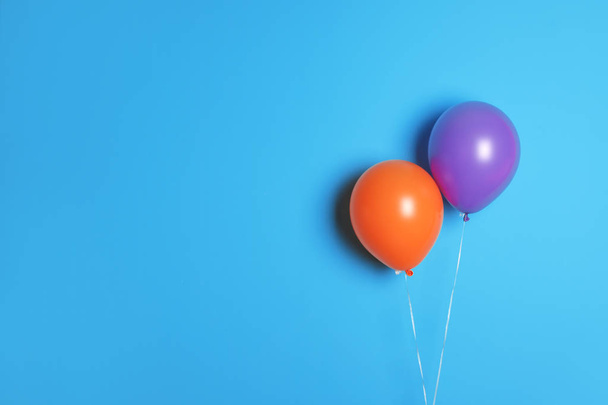 Different balloons on color background. Celebration time - Foto, Imagen