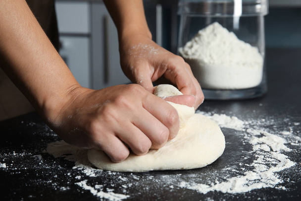 Woman kneading dough for pastry on table - Foto, imagen