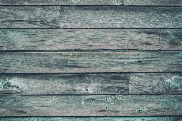 Old gray toned shabby wooden planks with cracked color paint - Fotó, kép