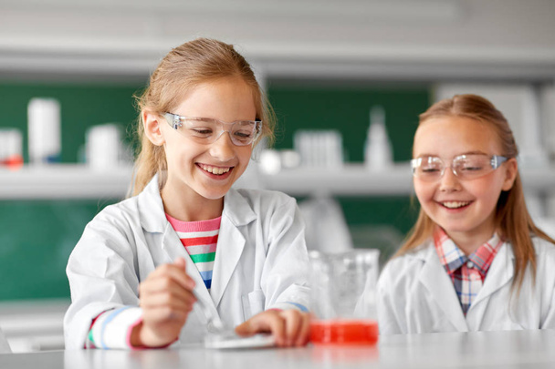 kids making chemical experiment at school lab - Fotó, kép