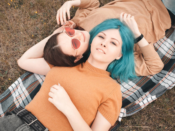 Two girls are lying on the grass - Zdjęcie, obraz