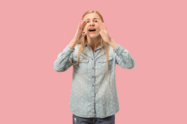 Isolated on pink young casual woman shouting at studio - Photo, image