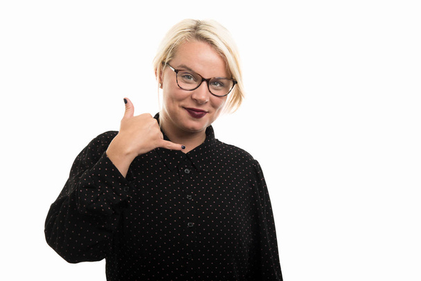 Portrait of young blonde female teacher wearing glasses showing call me gesture isolated on white background with copyspace advertising area - Fotó, kép
