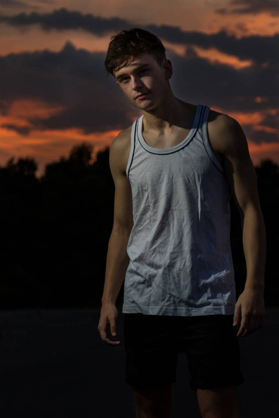 Young male adult outside at sunset - Foto, imagen