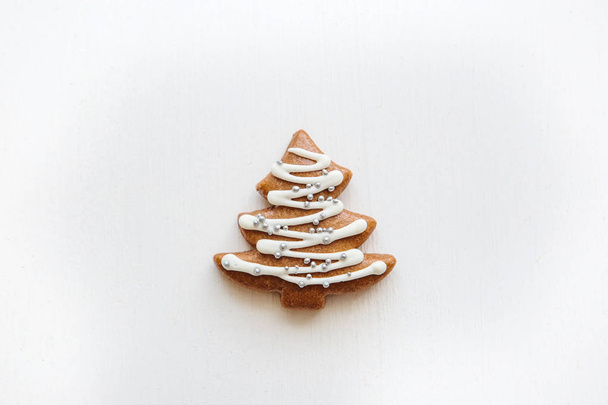 Traditional Christmas gingerbread cookie in the form of a Christmas tree on a white background - Photo, Image