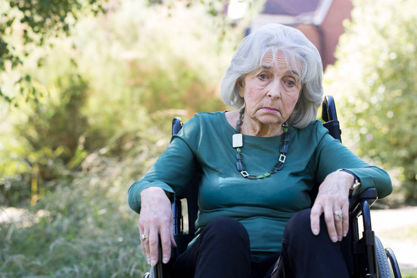 Depressed Senior Woman In Wheelchair Sitting Outdoors - Photo, Image