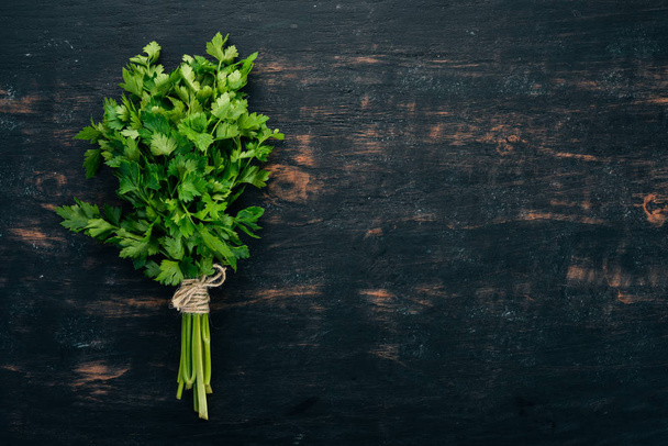Fresh parsley. Organic food. On a black background. Top view. Free space for text. - Valokuva, kuva
