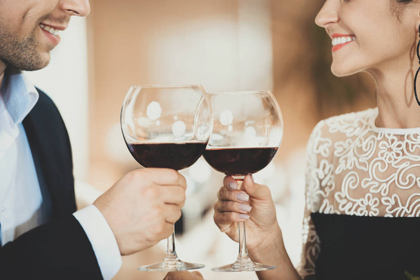 Young Couple in Love Drinking Wine Clink Glasses - Photo, Image