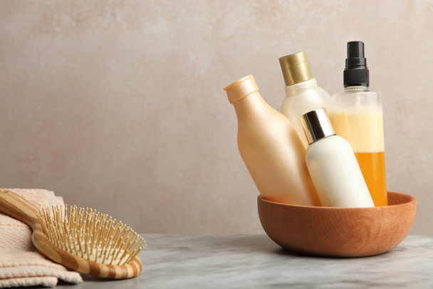 Hair care products on marble table on neutral background. - Φωτογραφία, εικόνα