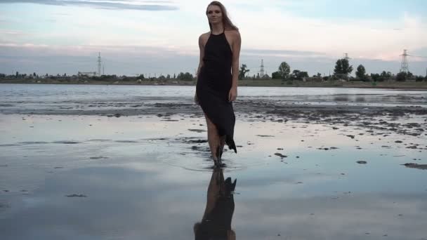 Adorable Slender Blonde Walk by Flat Surface of Shallow Salt Firth with Healthy Black Mud. - Footage, Video