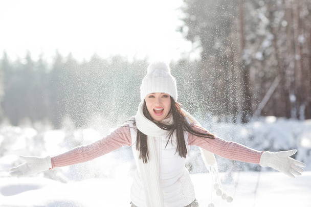 Cheerful young woman in winter time outdoors having fun - Foto, Imagen