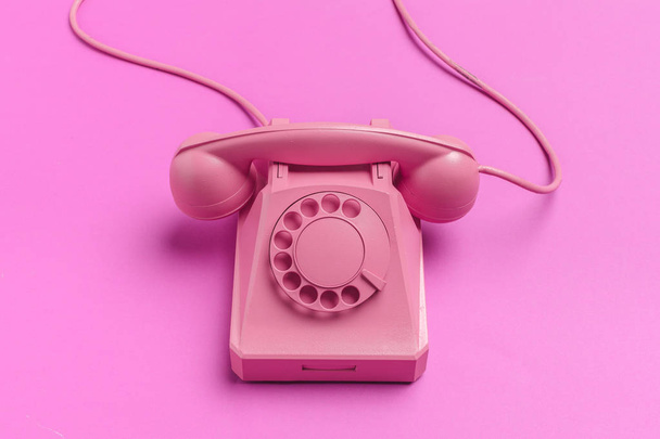 vintage phone on color background - Foto, afbeelding