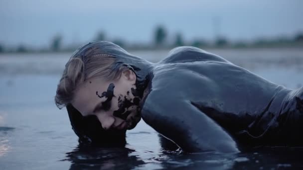 Adorable Slender Blonde Get Smeared with a Black Mud looks like Petroleum Oil Naphtha - Footage, Video
