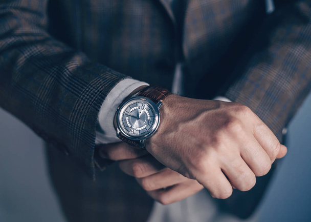 Vintage smart casual outfit outdoor.Fashion model man posing in office.Suited man posing.closeup fashion image of luxury watch on wrist of man.body detail of a business man.Not isolated. - Foto, Bild