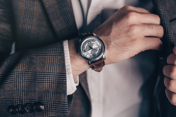 Vintage smart casual outfit outdoor.Fashion model man posing in office.Suited man posing.closeup fashion image of luxury watch on wrist of man.body detail of a business man.Not isolated. - 写真・画像