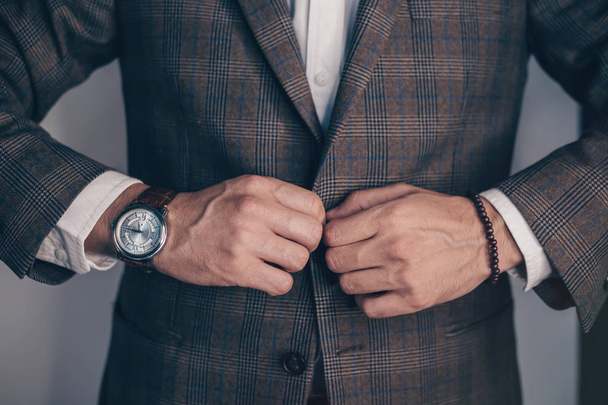 Vintage smart casual outfit outdoor.Fashion model man posing in office.Suited man posing.closeup fashion image of luxury watch on wrist of man.body detail of a business man.Not isolated. - Фото, изображение