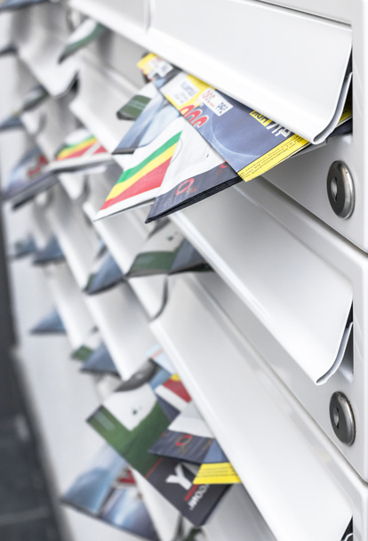 Moderne postvakken gevuld van folders. Business en reclameconcepten. Ondiepe scherptediepte. - Foto, afbeelding