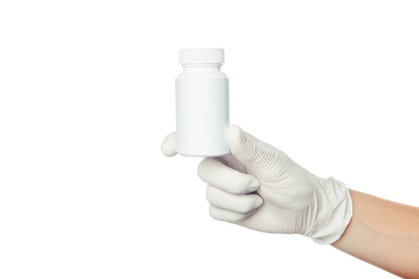 doctor's hand in white sterilized surgical glove holding medicine - Photo, image