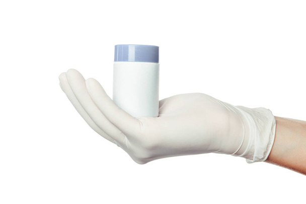doctor's hand in white sterilized surgical glove holding medicine - Фото, изображение