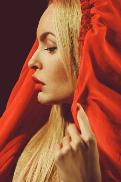 blonde woman in red dress with hood - Φωτογραφία, εικόνα