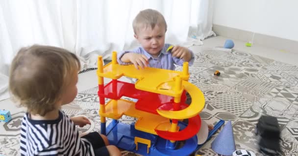 Bambini felici che giocano con macchine giocattolo a pavimento
 - Filmati, video
