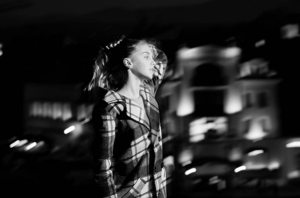 night city with girl, blonde young model in black coat - Photo, Image