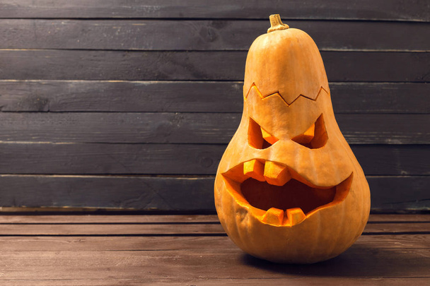 Scary Halloween pumpkin on dark background - 写真・画像
