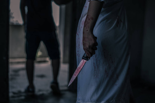 Ghost woman holding knife for kill a man with in house. Horror. Halloween. - Valokuva, kuva