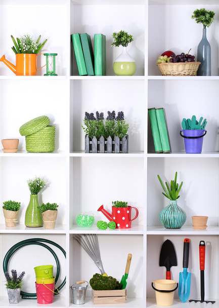 Beautiful white shelves with different gardening related objects - Foto, imagen