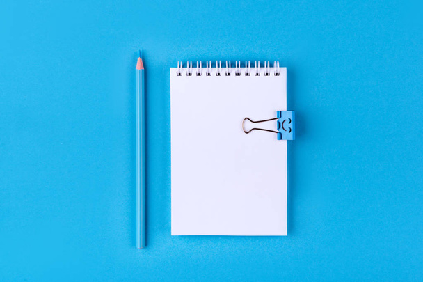 Top view of Blank notebook with peb on colorful background blue with copy space. - Photo, Image