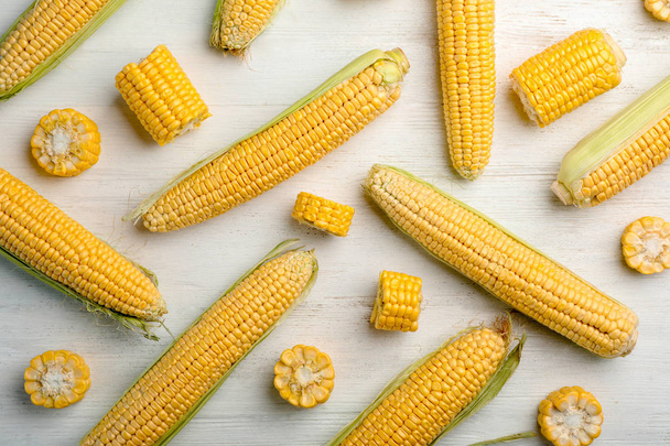 Flat lay composition with tasty sweet corn cobs on wooden background - Foto, Imagem