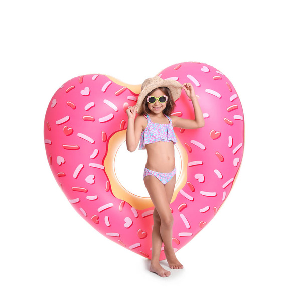 Cute little girl with inflatable heart on white background - Foto, Imagen