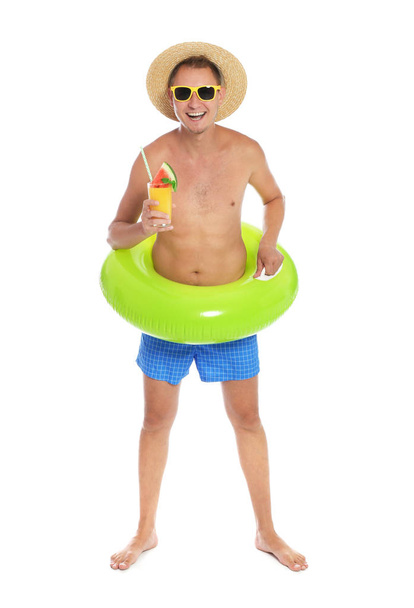 Shirtless man with inflatable ring and glass of cocktail on white background - Foto, Imagen