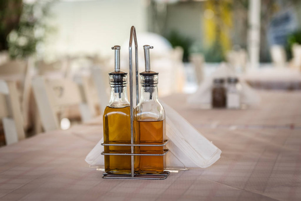 Olive oil and balsamic vinegar on a Greek Mediterranean restaurant table - Photo, Image