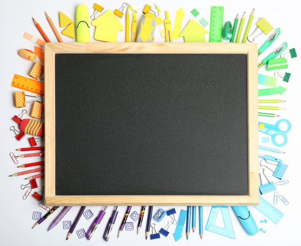 Composition with different school stationery and small chalkboard on white background, top view - Φωτογραφία, εικόνα