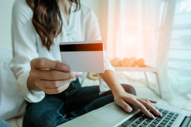 Hands holding credit card and using laptop. Online shopping - Fotó, kép