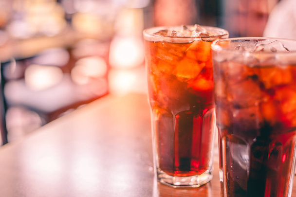 Two glass soft drink with ice in restaurant background - Photo, Image