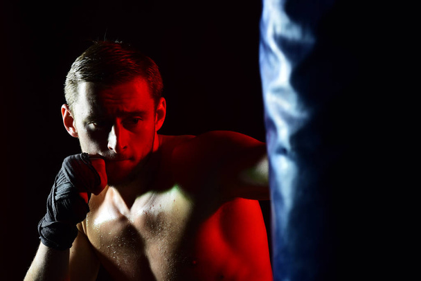 Training concept. Man boxer training in gym. Sportsman punch training bag. Training hard or go home - Фото, зображення