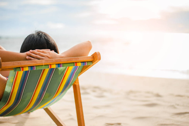 Woman relaxing on beach, looking at sea. Copy space. - Fotografie, Obrázek
