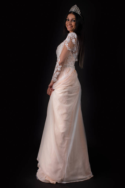 Fashion portrait of pretty sexy young brunette woman in white dress posing on dark wall background  - Fotografie, Obrázek
