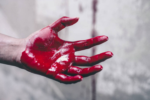 Horror Scene of a Woman with Bloody Hands . - Foto, afbeelding