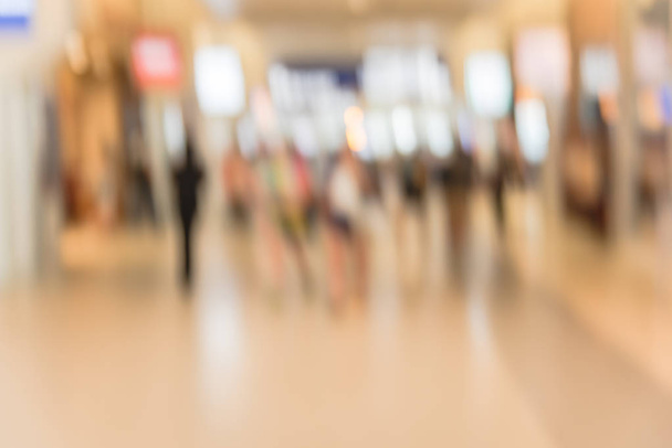 Gente con movimiento borroso caminando con equipaje en el aeropuerto americano. Pasajeros o turista abstracto borroso con bolsa, vista trasera. Viajero desenfocado a pie en la terminal del pasillo, concepto de transporte
 - Foto, Imagen