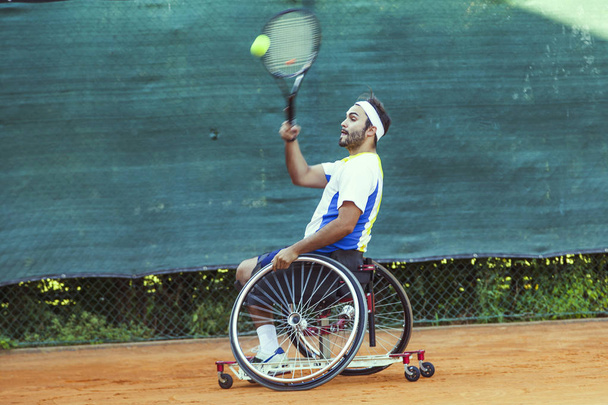 disabled tennis player hits the ball forehand during a match outdoor - Photo, Image