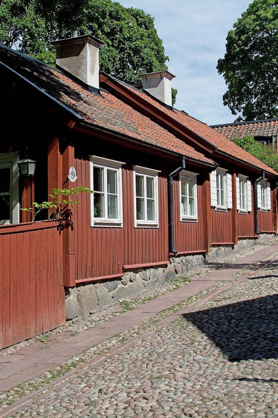 STOCKHOLM, SWEDEN - JULY 11, 2018: Old red wood homes in hills of Sodermalm on July 11, 2018 in Stockholm, Sweden. - Fotó, kép