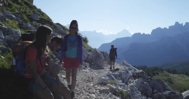 Cuatro amigos caminando por senderos de senderismo y relajarse. Grupo de amigos personas viaje de aventura de verano en la naturaleza de montaña al aire libre. Viaja explorando Alpes, Dolomitas, Italia. 4k cámara lenta 60p video
 - Metraje, vídeo