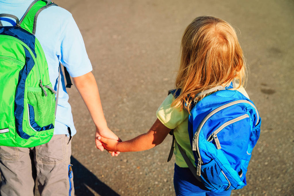 маленький хлопчик і дівчинка тримаються за руки йдуть до школи
 - Фото, зображення